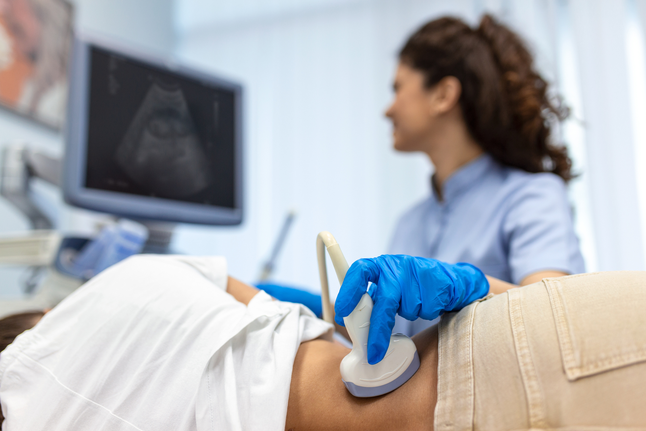 ultrasound-tech-doing-ultrasound-on-patient-stomach
