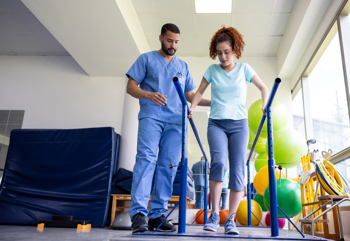 physical-therapist-helping-patient-walk